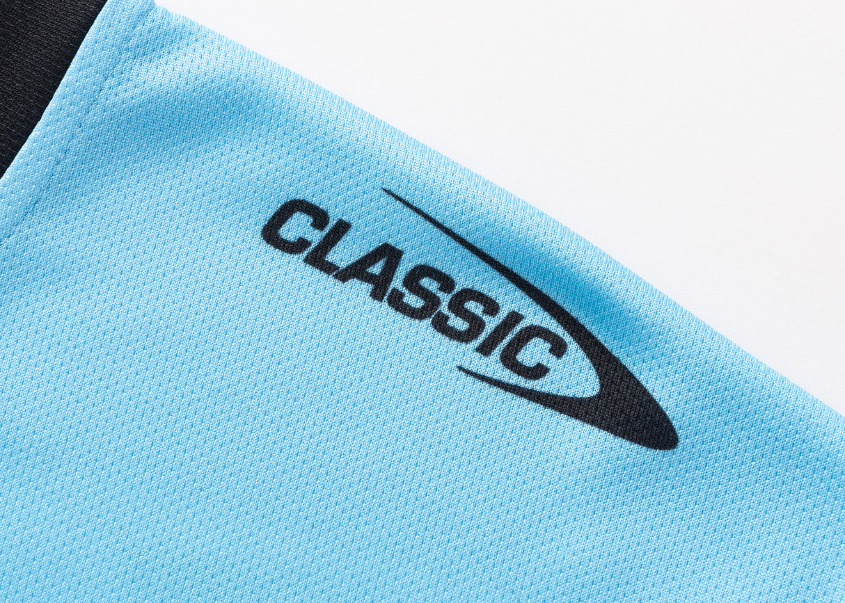 Close-up of blue fabric with black "CLASSIC" logo and swoosh, evoking the Sharks NRL 25/26 Replica Home Jersey by Classic Sportswear.