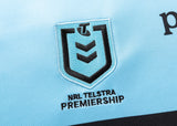 Close-up of the NRL Telstra Premiership logo embroidered on light blue fabric, reminiscent of the iconic Sharks NRL 25/26 Replica Home Jersey by Classic Sportswear.