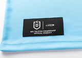 A light blue fabric similar to the Sharks NRL 25/26 Replica Home Jersey by Classic Sportswear, featuring a black patch with the NRL Telstra Premiership logo and "Classic".