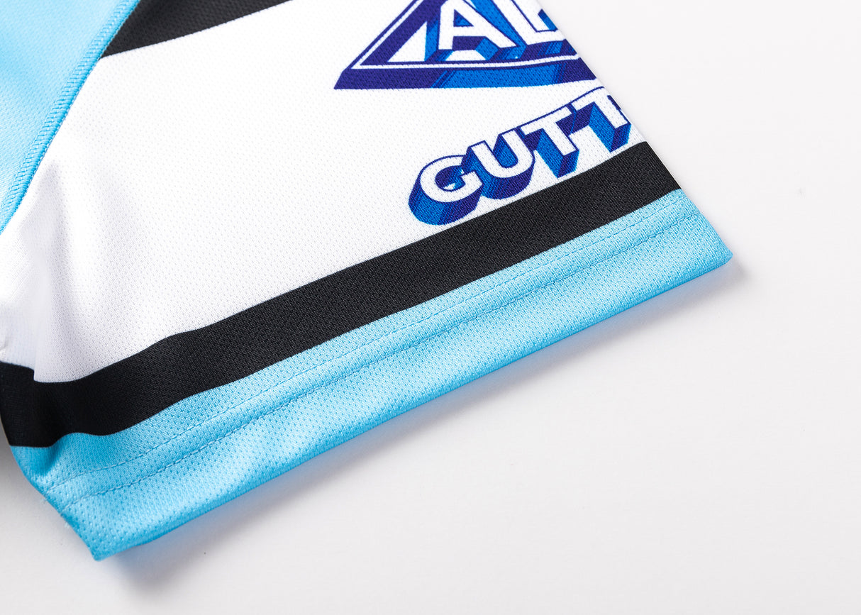 Close-up of the Sharks NRL 25/26 Replica Home Jersey by Classic Sportswear in blue, white, and black, featuring partial text "CUTT" and part of the Cronulla Sutherland Sharks' famous logo.