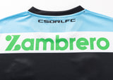 Close-up of the back of a Sharks NRL 25/26 Replica Home Jersey by Classic Sportswear in light blue and black, with "CSDRLFC" at the top and "Zambrero" in green across the middle.