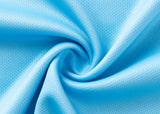 Close-up of blue fabric with a swirling design reminiscent of the Sharks NRL 25/26 Replica Home Jersey by Classic Sportswear, highlighting a textured surface and soft folds.