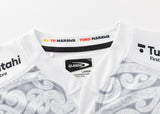 A white sports jersey with intricate gray patterns and Classic Sportswear labels has a collar featuring "KO TO MANAWA - TOKO MANAWA" in yellow and red, highlighting the heritage of the Gallagher Chiefs Super Rugby Replica Away Jersey 25/26 by Classic Sportswear.