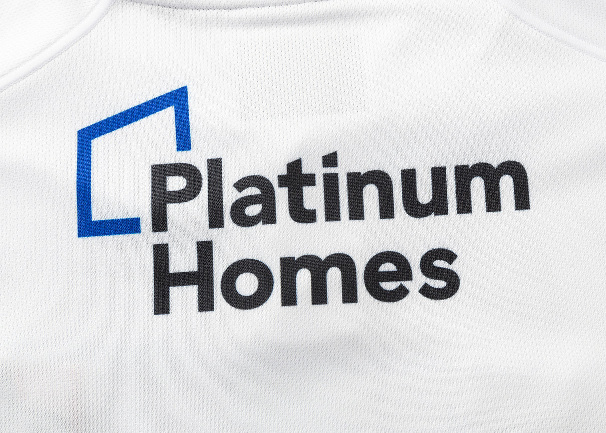 White fabric features "Platinum Homes" and a blue angular line logo in black, similar to the design on the Gallagher Chiefs Super Rugby Replica Away Jersey 25/26 by Classic Sportswear, capturing the essence of Super Rugby.