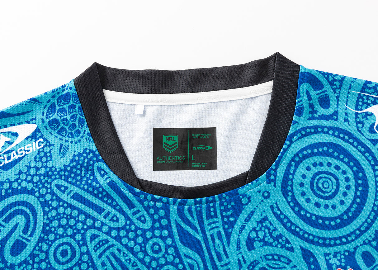 The NRL Indigenous All Stars 25/26 Replica Home Jersey by Classic Sportswear is a blue patterned jersey with Indigenous-inspired designs and logos on the front, branded "NRL Authentics" inside the collar.