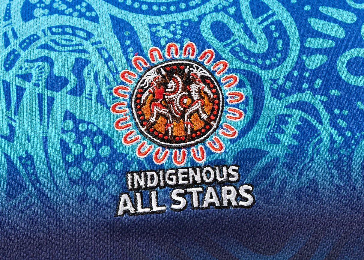 Blue and black NRL Indigenous All Stars 25/26 Replica Home Jersey by Classic Sportswear, showcasing circular indigenous designs with two figures, intricate patterns, and text: "NRL Indigenous All Stars.