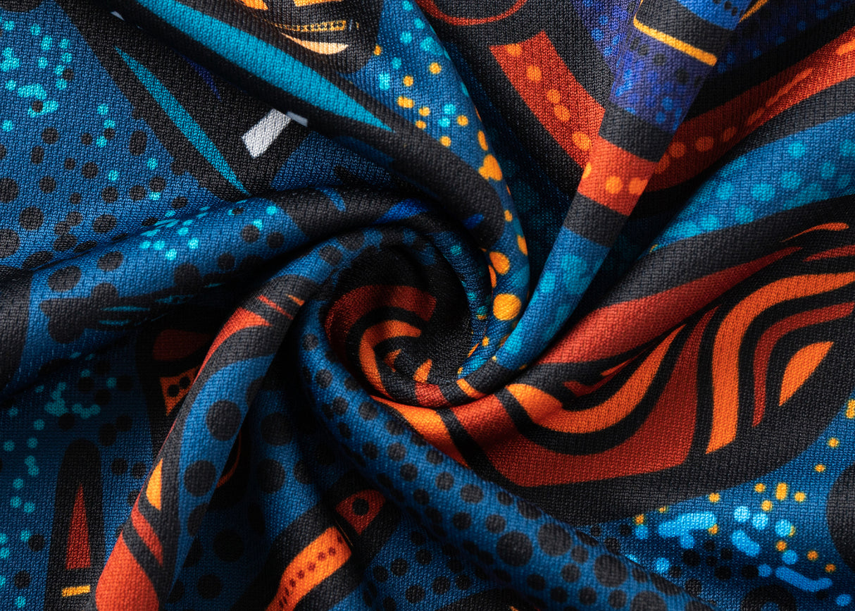 Close-up of a vibrant fabric with swirling patterns, showcasing bold geometric designs in blue, orange, and black tones that capture the unique style of the NRL Indigenous All Stars 25/26 Replica Home Jersey by Classic Sportswear.