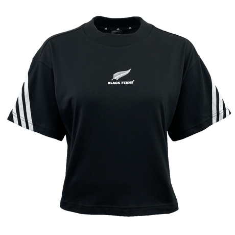 The Women's Black Ferns 3-Stripe Tee by adidas is a black short-sleeve shirt featuring a white fern logo and "BLACK FERNS" text on the chest. It boasts stylish white stripes on the sleeves and is made from medium-weight cotton for comfort and durability.