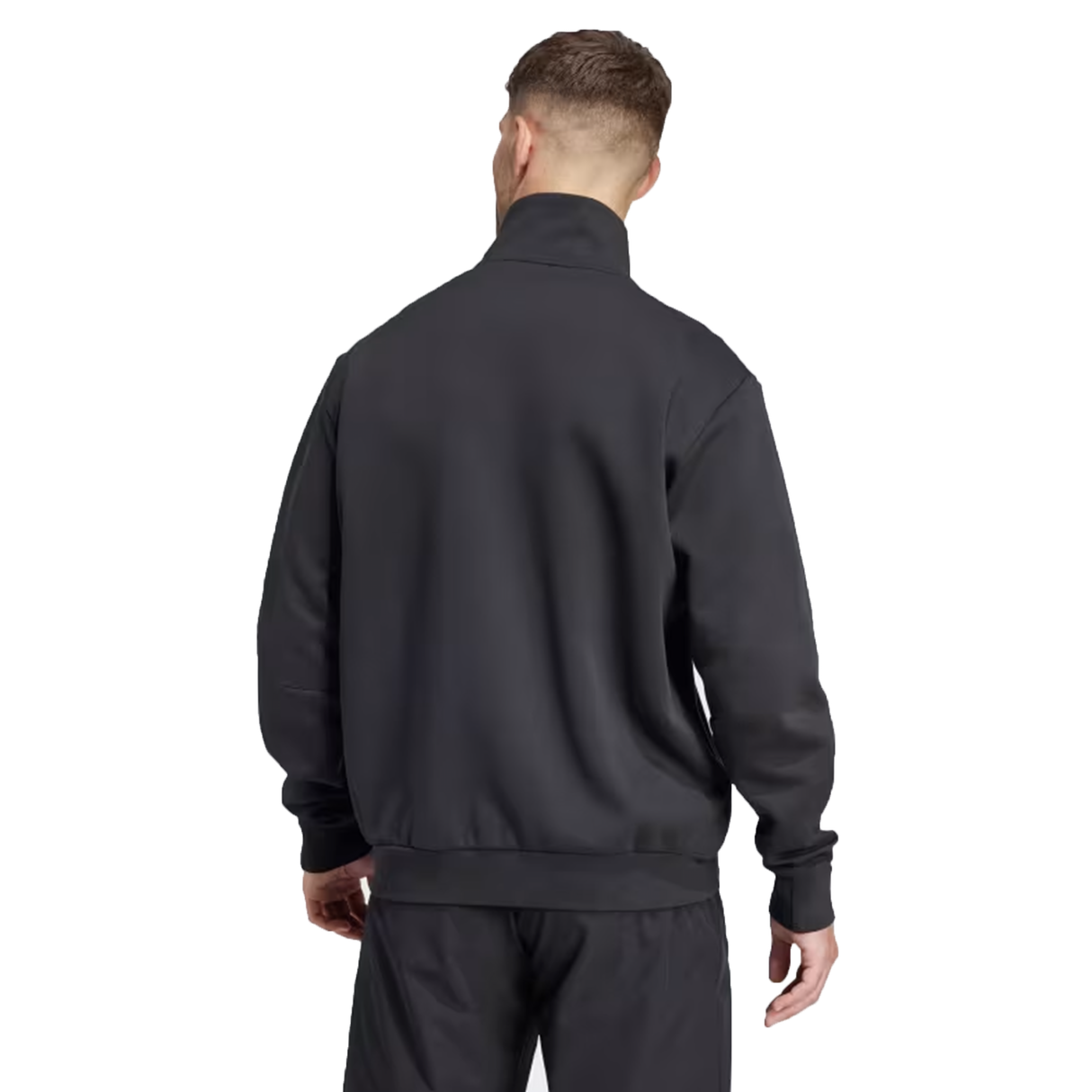 A person in an Adidas rugby tracksuit faces away, highlighting the sleek design and performance of the adidas All Blacks 24/25 Anthem Jacket.