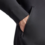 A person's hand is partially inside the zippered pocket of an All Blacks 24/25 Anthem Jacket by Adidas, featuring AEROREADY technology for ultimate comfort.