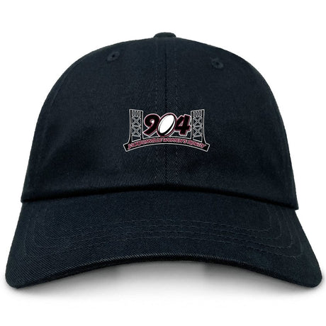 The Jacksonville Women's Rugby Adult Low-Profile Cotton Twill Dad Cap by EMB Alpha Broder is a black cap featuring an embroidered "904" design framed by bridge structures on the front, and crafted from durable cotton twill.