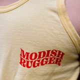 Close-up of a yellow Modish Rugger Saturday's a Rugby Day tank top showcasing red text that says "MODISH RUGGER," paired with a discreet beer bottle graphic.