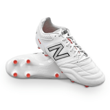 A pair of white New Balance Wide 442 V2 Pro FG soccer cleats with silver logos, red studs on the soles, and a premium kangaroo leather upper for ultimate performance on firm ground.