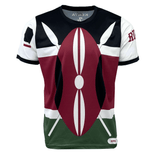 A short-sleeve shirt featuring a design with spears and shield elements, primarily in black, red, white, and green colors. The word "KENYA" is printed on the back inside collar. This Nations of Rugby Kenya 7s Rugby Flag Supporters Jersey by Admiral is perfect for any supporter looking to represent their team with pride.