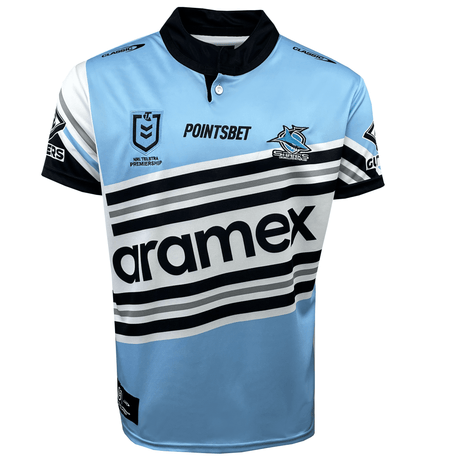 A blue, black, and white sports jersey with various sponsors' logos, including "Aramex," "PointsBet," and a logo with a shark and shield. This Sharks NRL Heritage Jersey by Classic Sportswear features horizontal stripes across the chest, embodying the essence of an NRL Heritage Jersey.