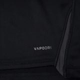 Close-up of a black fabric garment with the word "VAPODRI" printed on it in white letters. The Canterbury Vapodri Evader Jersey features seams and a textured surface, showcasing its VapoDri finish and moisture-wicking technology.