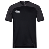 The Canterbury Vapodri Evader Jersey is a black short-sleeve jersey featuring contrasting dark grey shoulder panels. The Canterbury logo adorns the left chest, and "VapoDri" is printed on the lower right side, highlighting its moisture-wicking technology.