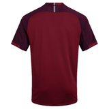 Back view of the Canterbury Vapodri Evader Jersey, a short-sleeved maroon athletic shirt with darker maroon shoulder panels and a small vertical reflective strip at the top center, featuring VapoDri finish for enhanced moisture-wicking technology.