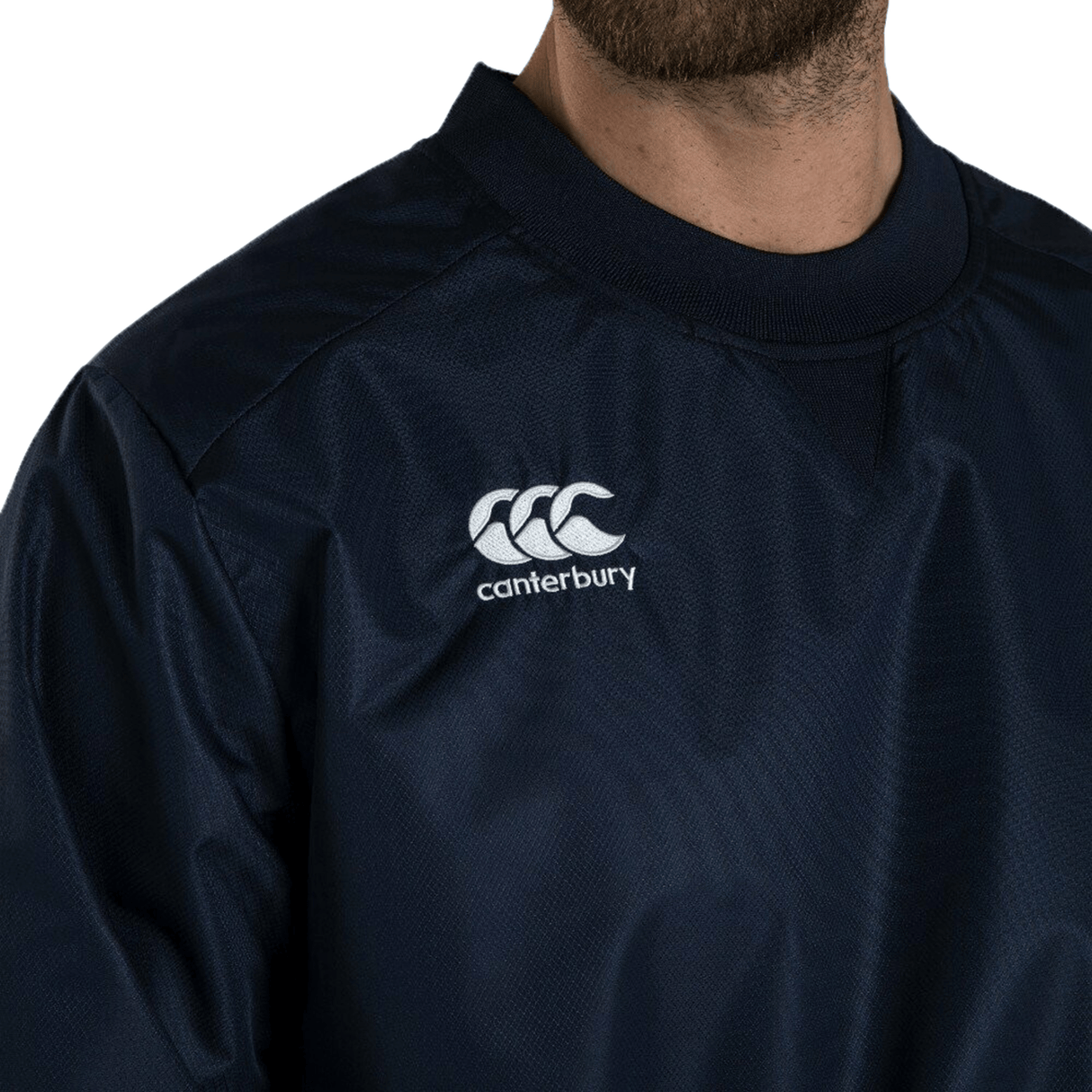 A man with a beard wearing a blue Canterbury Club Vaposhield Contact Top shirt.