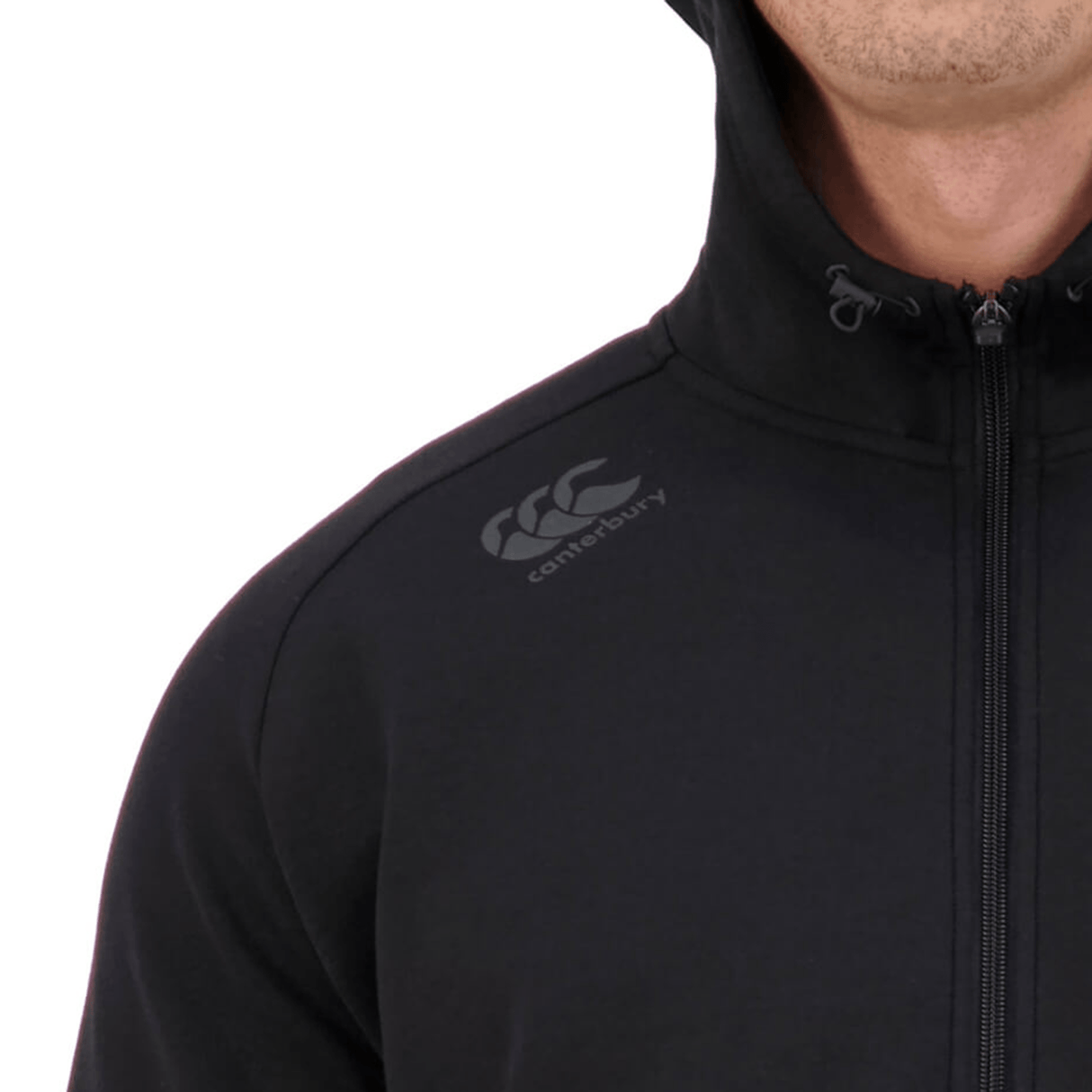 A man wearing a Canterbury Tempo Vapodri Full-Zip Hoodie with moisture-wicking properties and Canterbury branding.