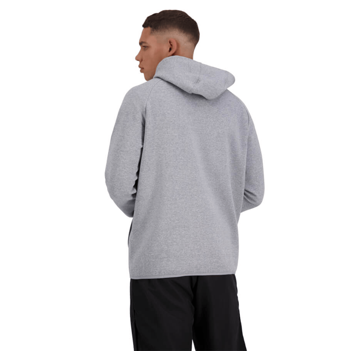 The back view of a man wearing a Canterbury Tempo Vapodri Full-Zip Hoodie with moisture-wicking properties.