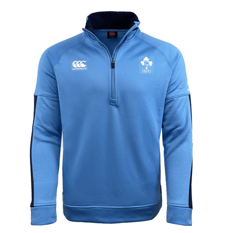 The Ireland Rugby 1/2 Zip Training Top by Canterbury is a light blue, long-sleeve top featuring Canterbury’s ThermoReg technology, the Canterbury logo on the right chest, and the IRFU emblem on the left chest, designed with a half-zip.