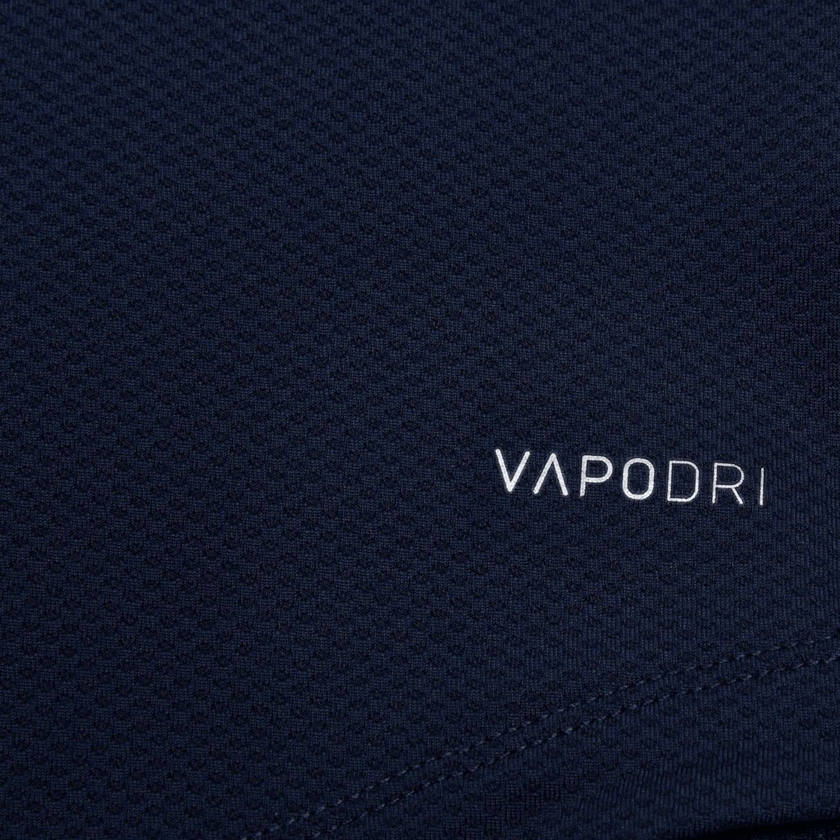 Close-up of textured, lightweight fabric featuring "VAPODRI" in bold white text, highlighting Canterbury's advanced Vapodri technology in the Women's Canterbury Elite Training Tee.