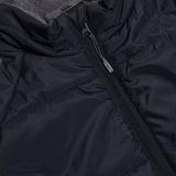 Close-up view of a black Canterbury Elite Microlite Gilet showing the zipper and quilted texture.