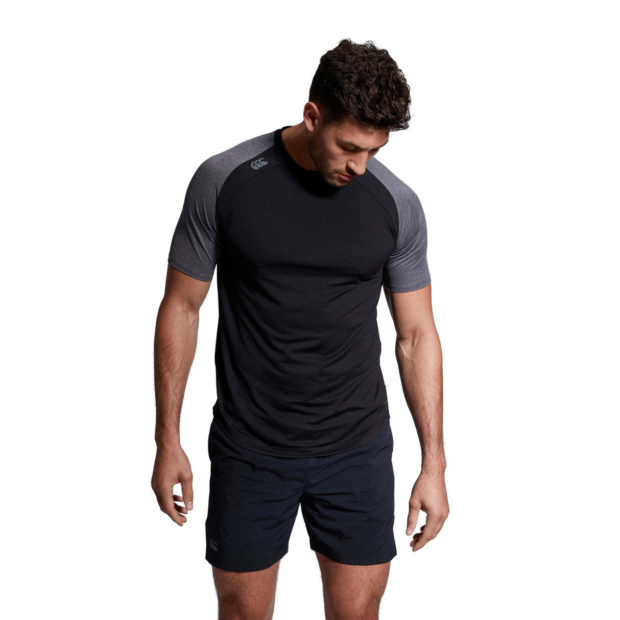 A man wearing a Canterbury Elite Training Tee and shorts.