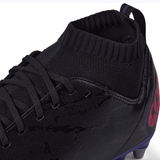 Close-up view of a black Canterbury Stampede Pro SG rugby boot with a knitted ankle collar, designed for soft ground traction.