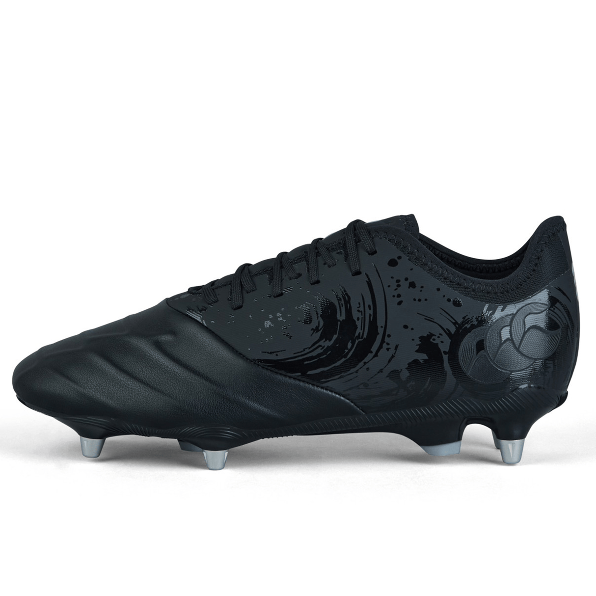 The Canterbury Phoenix Genesis Pro SG - Black/Silver Metallic is a soft ground boot that boasts a sleek black design, complete with silver-tipped studs for optimal traction and a distinctive swirling pattern on the side.