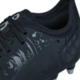 Close-up image of the Canterbury Phoenix Genesis Pro SG - Black/Silver Metallic, a black soft ground boot by Canterbury with textured patterns and intricate designs. Featuring black laces and studs on the sole for ultimate traction.