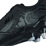 Close-up of the Canterbury Phoenix Genesis Pro SG Black/Silver Metallic soccer cleat featuring a textured design, metallic studs, and superior traction on soft ground.