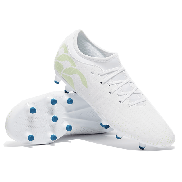 A pair of white Canterbury Speed Infinite Team FG rugby boots with green accents and blue studs.