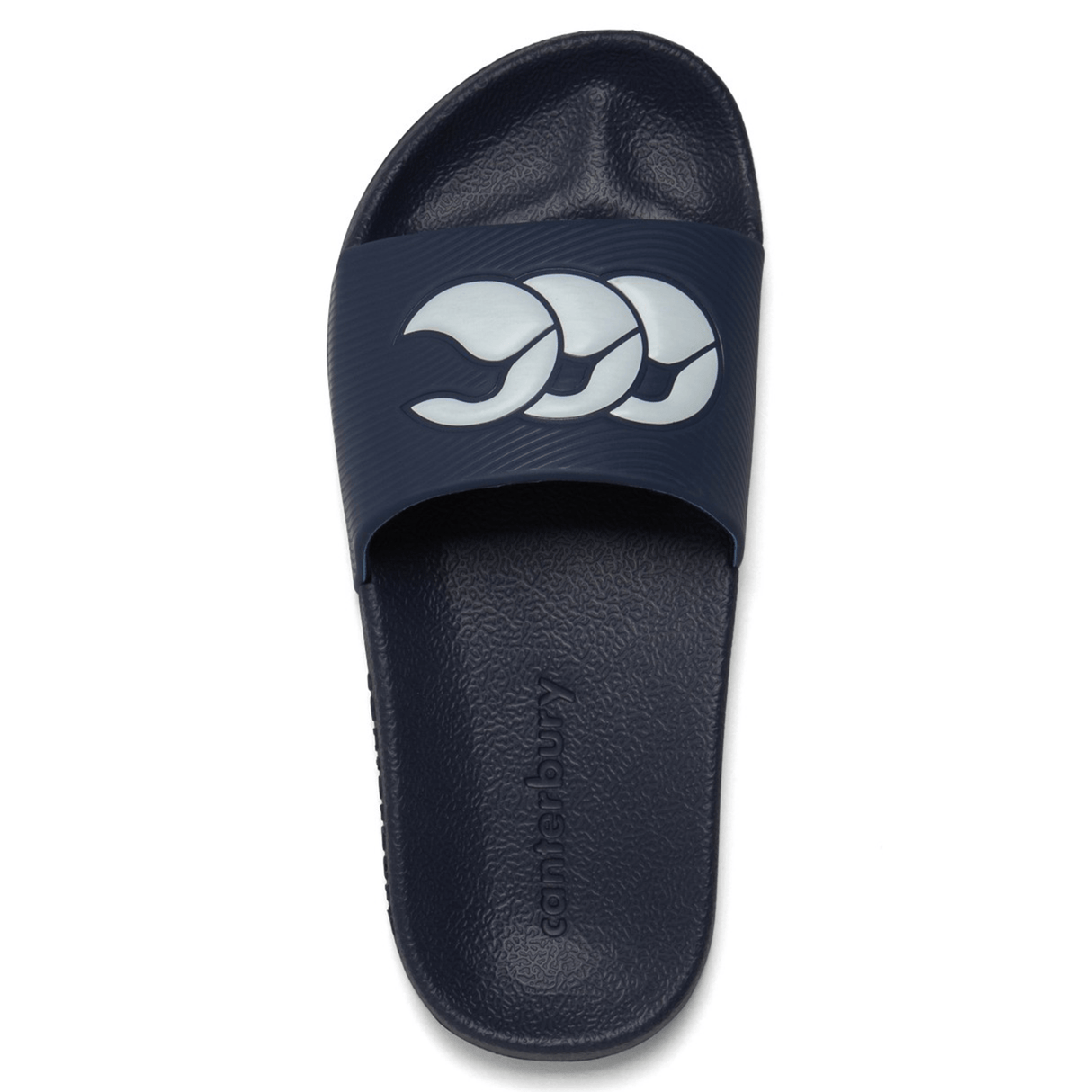 A navy Canterbury Wide Fit Slide sandal featuring a white, three-wave logo on the strap. The textured insole enhances overall comfort, and the brand name "Canterbury" is prominently displayed.