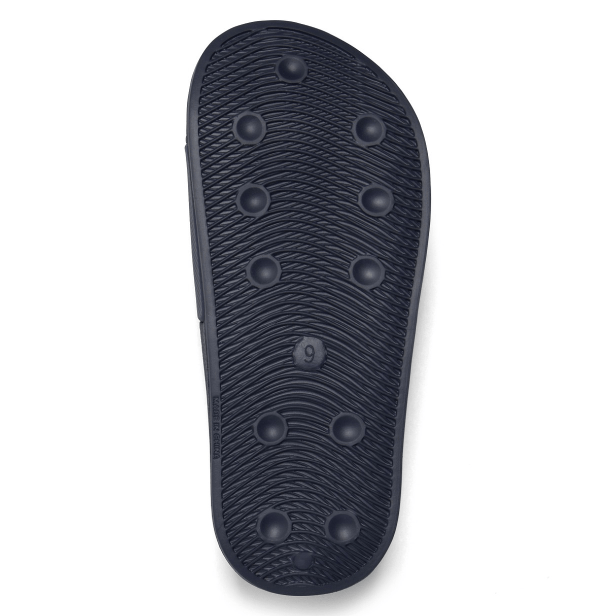 The image shows the sole of a navy Canterbury Wide Fit Slide with textured grooves and circular patterns, size marked as 9.