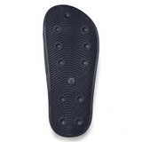 The image shows the sole of a navy Canterbury Wide Fit Slide with textured grooves and circular patterns, size marked as 9.