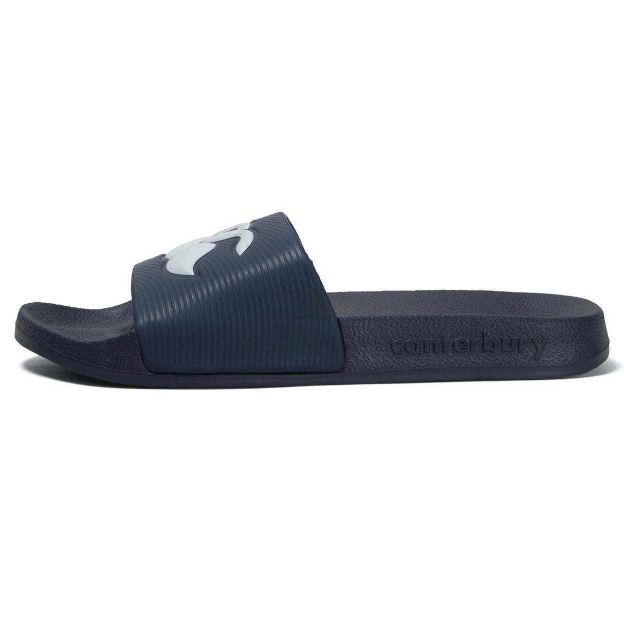 The Canterbury Wide Fit Slide - Navy features a single dark blue sandal with a wide strap adorned with a light blue Canterbury logo. The footbed is embossed with the word "canterbury." Designed for ultimate comfort, this slide is perfect for both casual wear and post-shower relaxation.