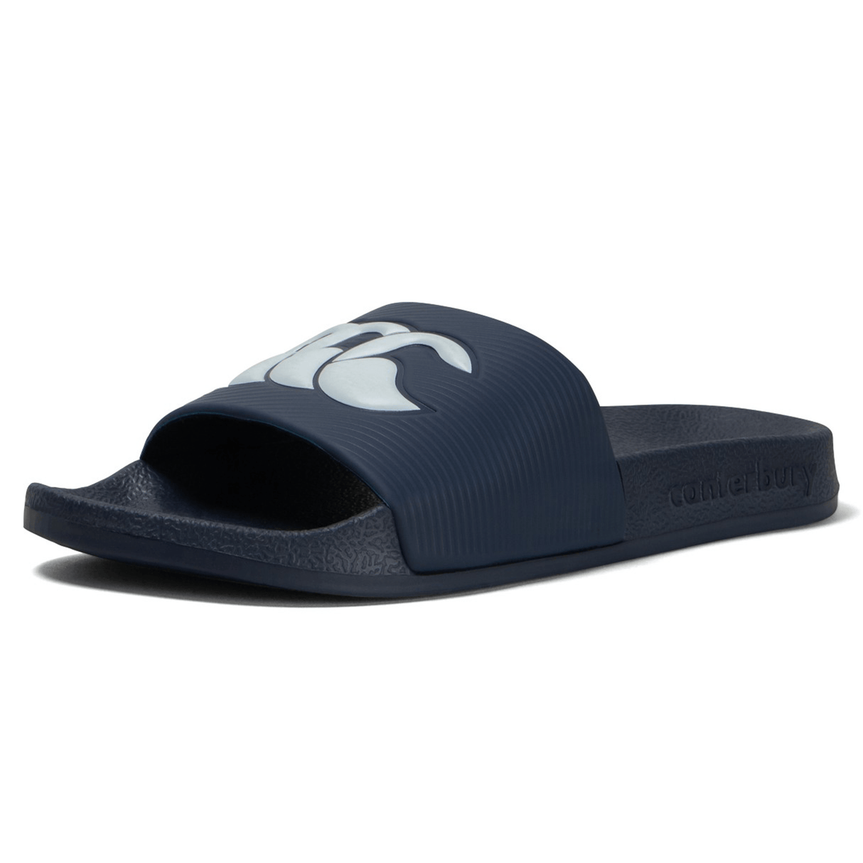 The Canterbury Wide Fit Slide - Navy is a sandal that combines comfort and style, featuring a navy blue color with a white logo on the strap and textured sole. The brand name "Canterbury" is embossed on the side.