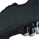 Close-up of the Canterbury Stampede Groundbreak Pro SG - Black/Silver Metallic soccer cleat, highlighting its textured upper material and metallic studs on the outsole designed for enhanced traction on soft ground and optimal power transfer.