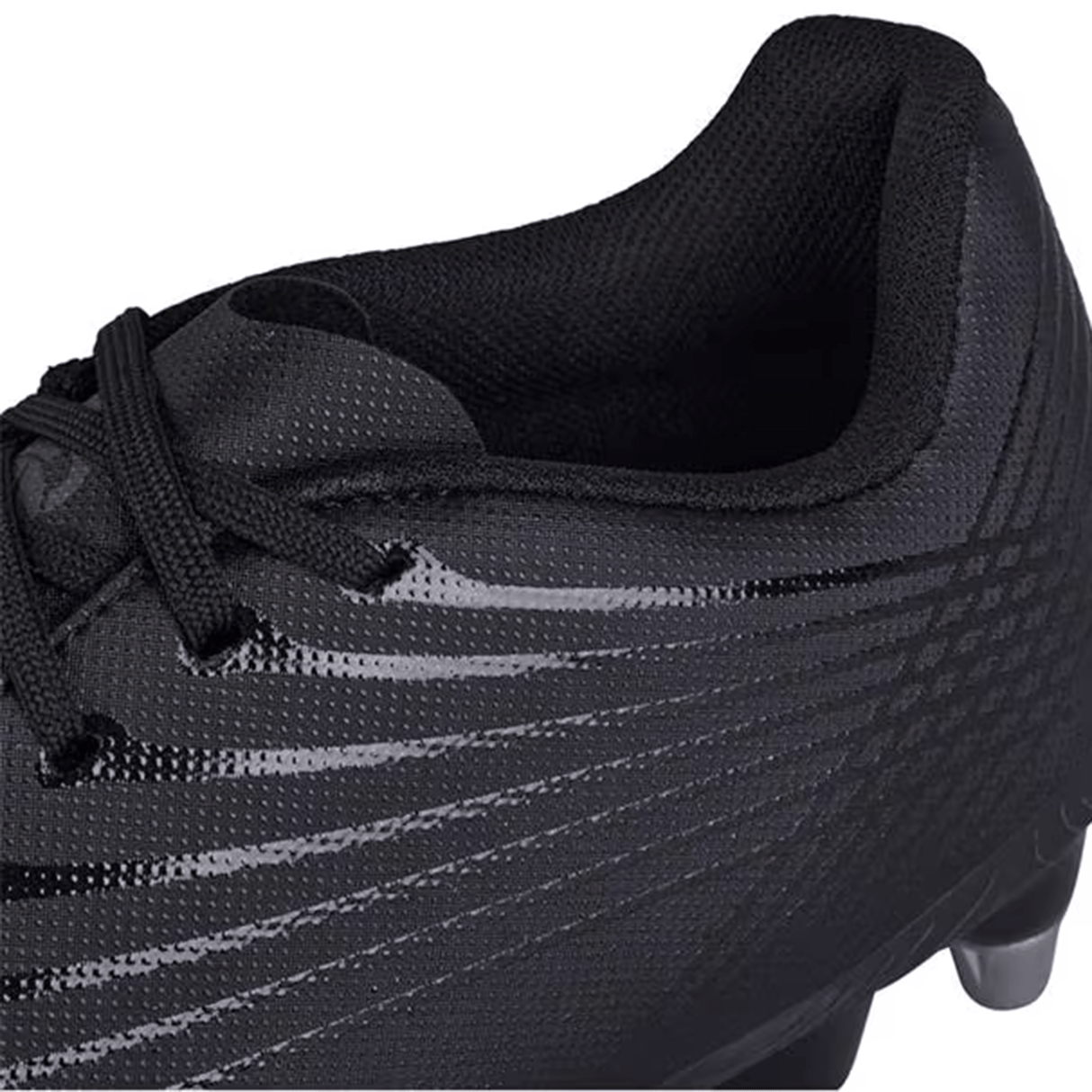 Close-up of the Canterbury Stampede Groundbreak Team SG cleat, featuring a black synthetic upper material with a textured design and black laces. The molded heel offers enhanced stability, ideal for players seeking precision on the field.