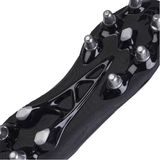 Close-up view of the sole of a Canterbury Stampede Groundbreak Team SG cleat in Black/Silver Metallic, featuring metal studs. The design is intricate with optimal stud placement for traction and includes an EVA footbed for enhanced comfort.