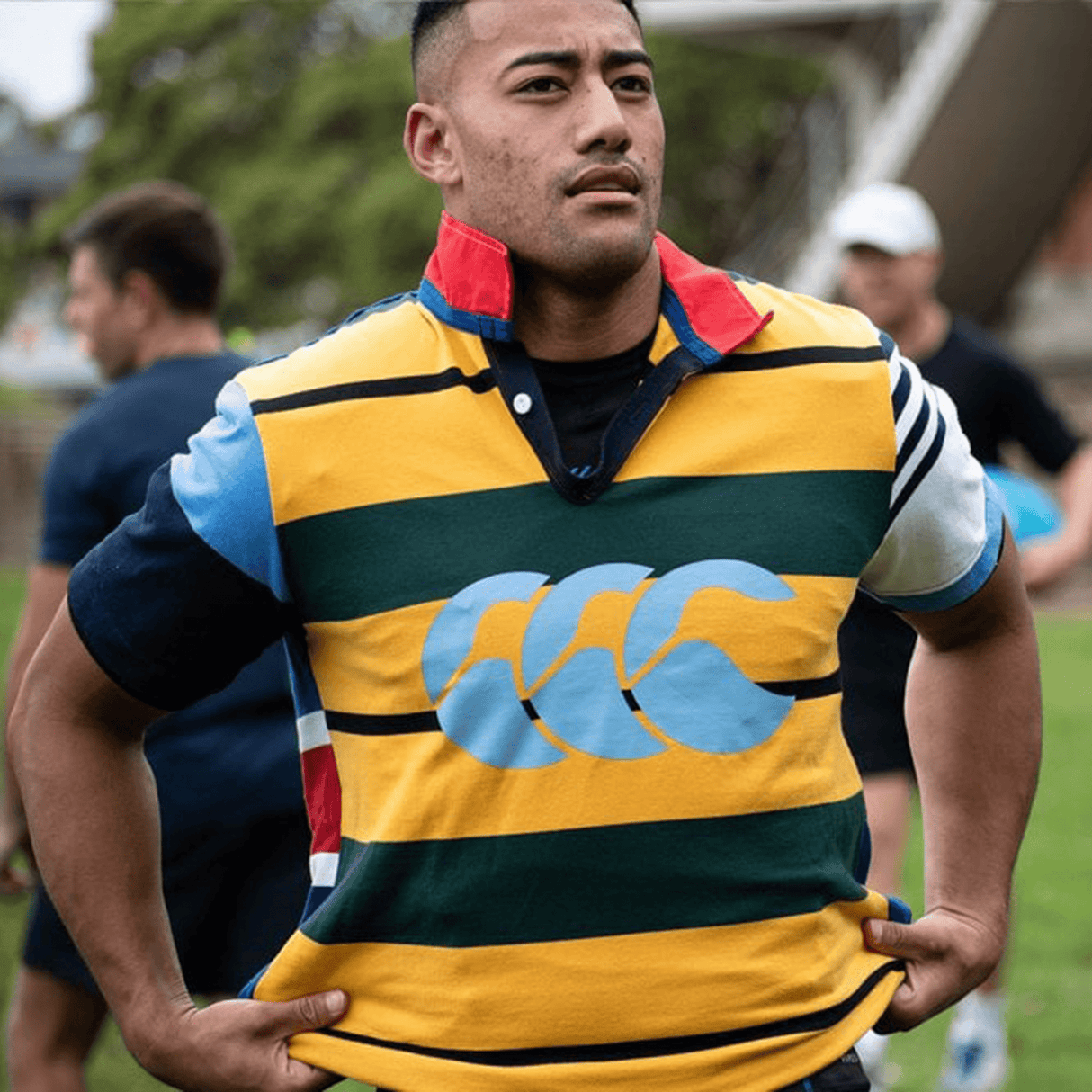 A man in a Canterbury Uglies Polo jersey standing on a field.