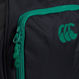 Close-up of a black fabric Ireland 24 Holdall Duffle Bag by Canterbury featuring a green zipper, a green logo on the front pocket, and a waterproof nylon interior.