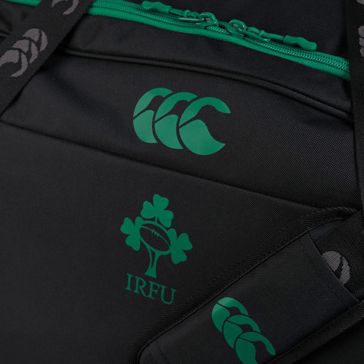 The Ireland 24 Holdall Duffle Bag by Canterbury features a black design with a green Canterbury logo, an IRFU shamrock emblem, green zipper details, and advanced Vaposhield Technology for ultimate protection.