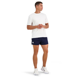 A person stands in a white t-shirt, Canterbury Classics Rugged Drill Short in navy, and white sneakers against a plain background.