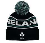 The Ireland 24 Text Bobble Hat by Canterbury is a black winter hat with a pompom, featuring the word "IRELAND" across the front and the IRFU logo with a shamrock below. This stylish accessory perfectly complements your winter wardrobe.