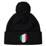 The newly arrived black Italy Shield Pom Pom Beanie by EMB Canterbury features an Italy Shield with vertical green, white, and red stripes.