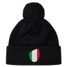 The newly arrived black Italy Shield Pom Pom Beanie by EMB Canterbury features an Italy Shield with vertical green, white, and red stripes.