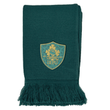 The Ireland 150th Anniversary Scarf by Canterbury is a green scarf with fringed ends, featuring an embroidered shield-shaped crest with clovers and "IRFU" text, celebrating Ireland's 150th Anniversary.